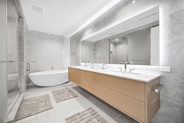 bathroom with independent shower and bath, vanity, and tile walls