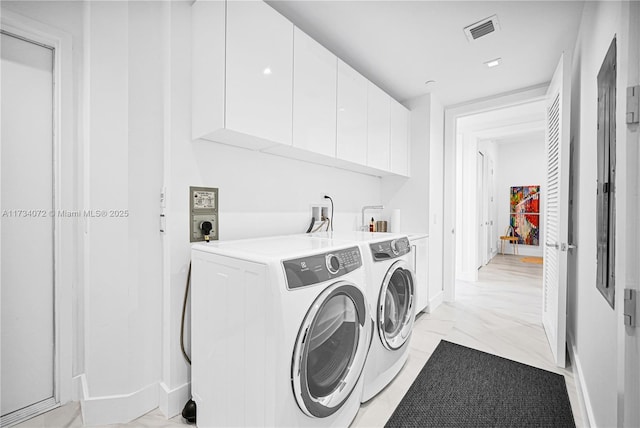 washroom with cabinets and independent washer and dryer