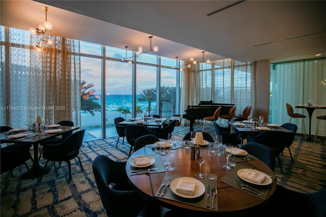 dining area with an inviting chandelier and expansive windows