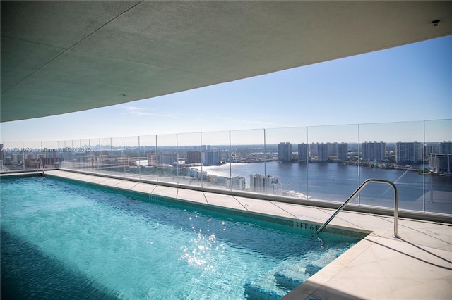 view of swimming pool with a water view