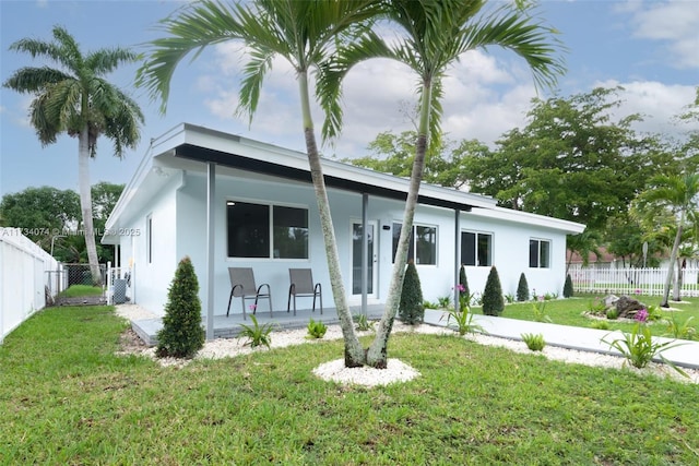 view of front of home featuring a front yard and covered porch