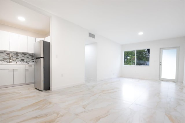 unfurnished living room with sink