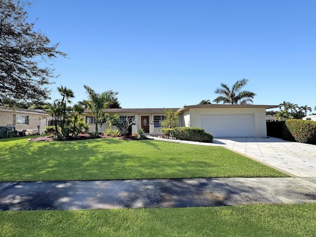 ranch-style house featuring a garage and a front yard