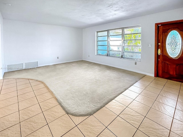 view of carpeted foyer entrance