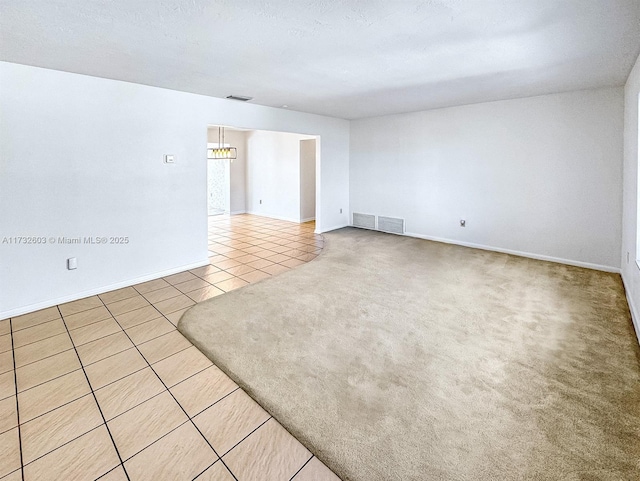 carpeted spare room with a textured ceiling