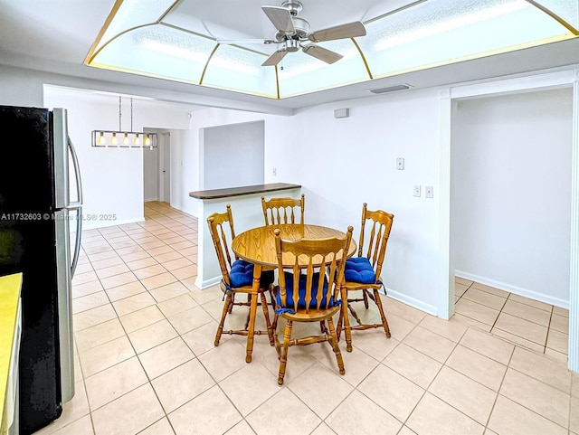 tiled dining space with ceiling fan