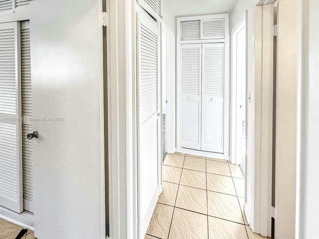 hall featuring light tile patterned floors