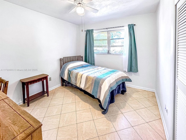 tiled bedroom with ceiling fan