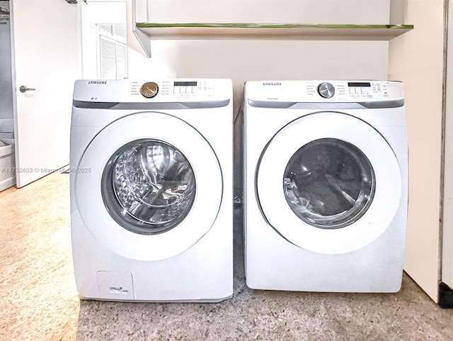 laundry area with washing machine and clothes dryer