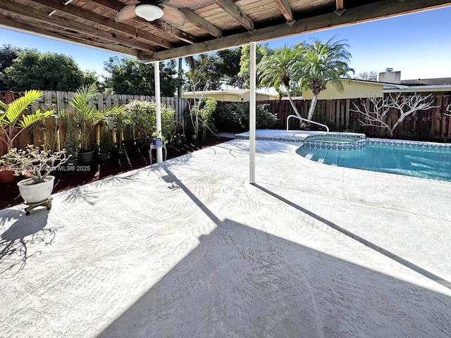 view of swimming pool featuring a patio and ceiling fan