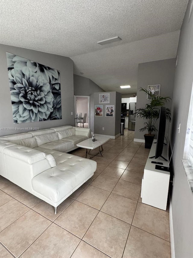 tiled living room featuring lofted ceiling and a textured ceiling