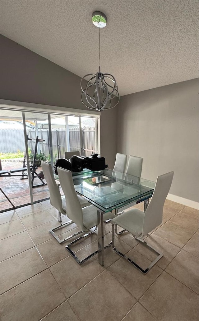 dining space featuring a notable chandelier, vaulted ceiling, a textured ceiling, and light tile patterned flooring