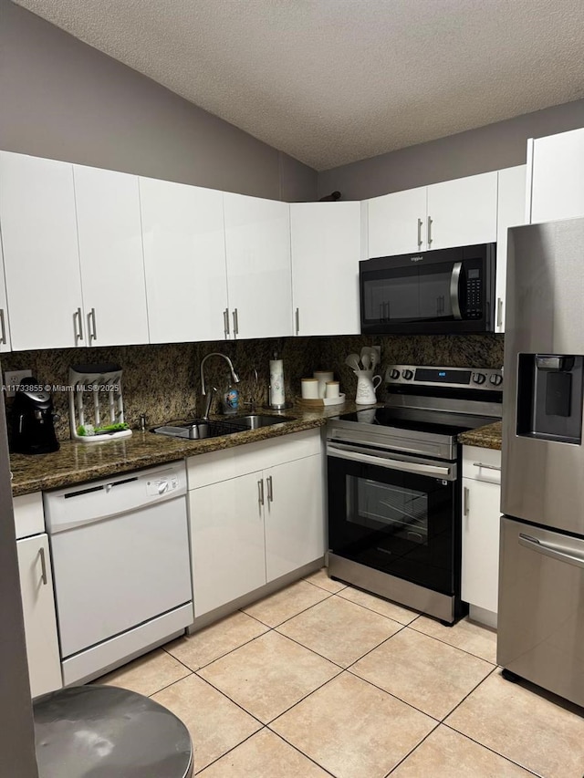 kitchen with white cabinetry, sink, stainless steel appliances, and a textured ceiling