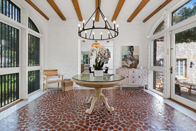 sunroom with beam ceiling and a chandelier