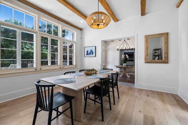 dining room with an inviting chandelier, beam ceiling, and light wood-type flooring