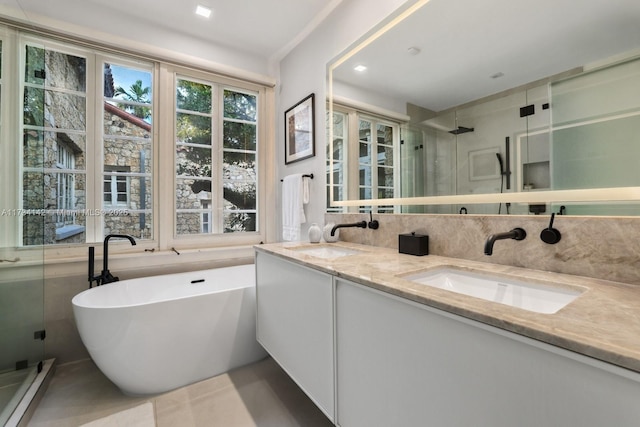 bathroom featuring vanity, independent shower and bath, tile patterned flooring, and a baseboard heating unit