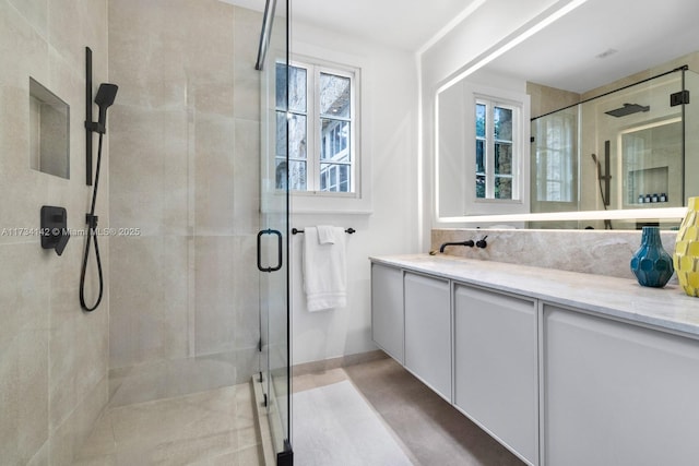 bathroom featuring vanity and an enclosed shower