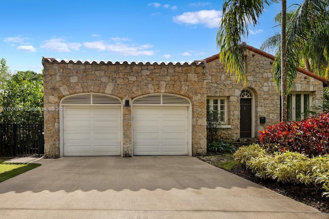 mediterranean / spanish home featuring a garage