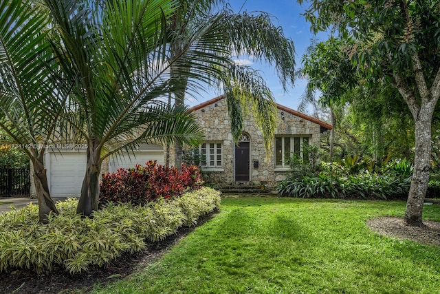 view of front of property featuring a garage and a front yard