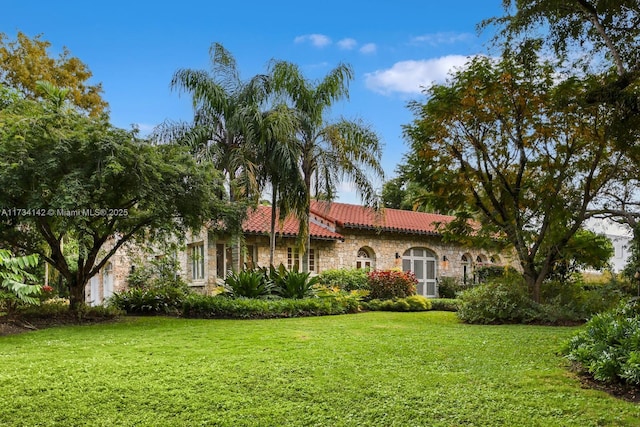 mediterranean / spanish home featuring a front yard