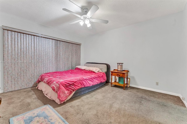 carpeted bedroom with a textured ceiling and ceiling fan