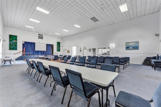 dining space with a towering ceiling