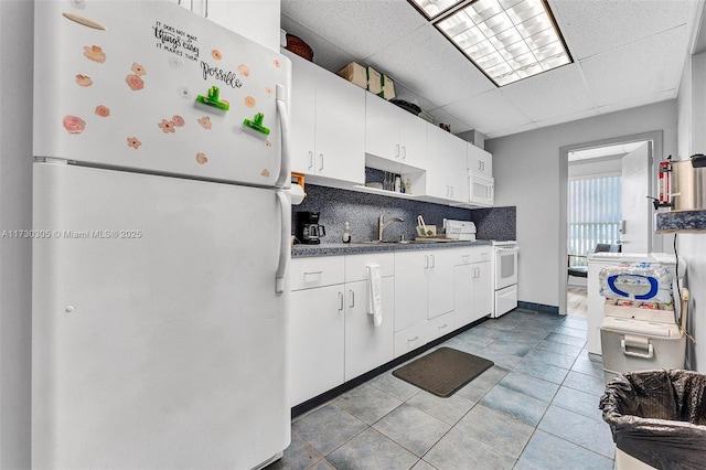 kitchen with white cabinetry, white appliances, a paneled ceiling, and tasteful backsplash