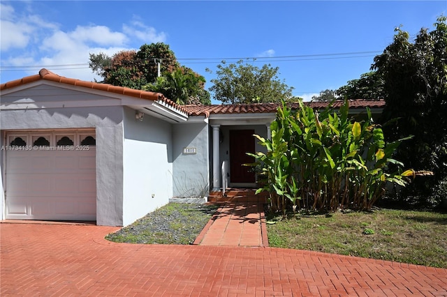 mediterranean / spanish house featuring a garage