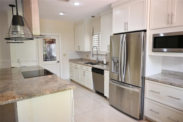 kitchen featuring appliances with stainless steel finishes, island range hood, pendant lighting, sink, and white cabinets