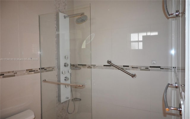 bathroom featuring a shower with door