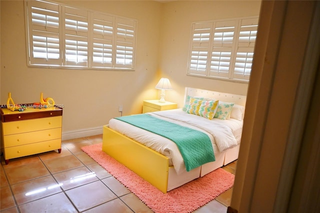 bedroom featuring multiple windows and tile patterned flooring