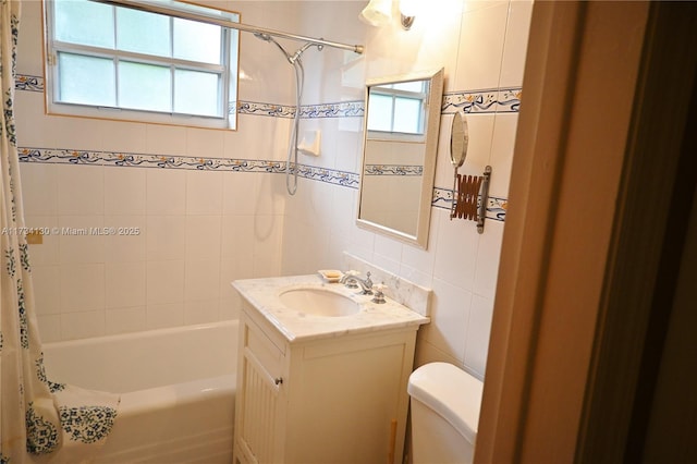 full bathroom with shower / bath combo with shower curtain, vanity, toilet, and tile walls