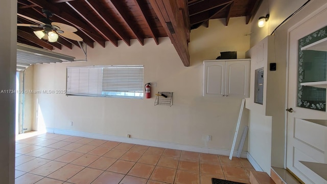 tiled spare room with wood ceiling, lofted ceiling with beams, and ceiling fan