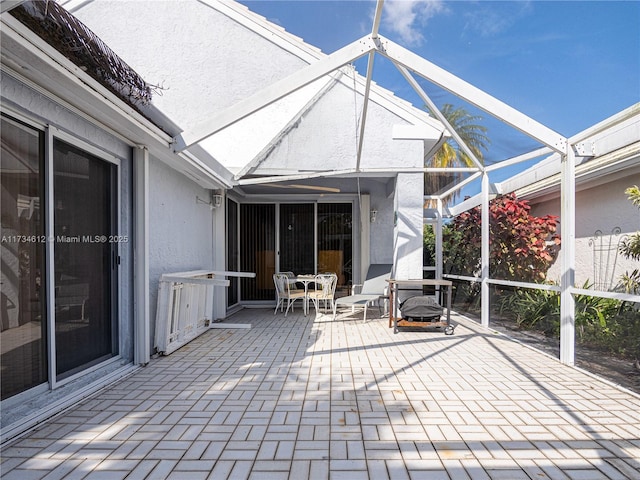 view of patio / terrace featuring a lanai