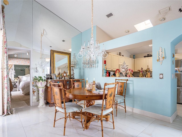 tiled dining area featuring lofted ceiling and a chandelier