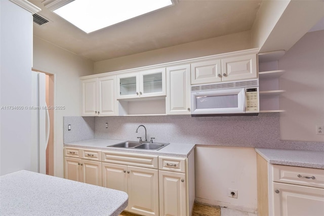 kitchen featuring white cabinetry, sink, and decorative backsplash