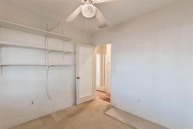 unfurnished bedroom with light colored carpet and ceiling fan