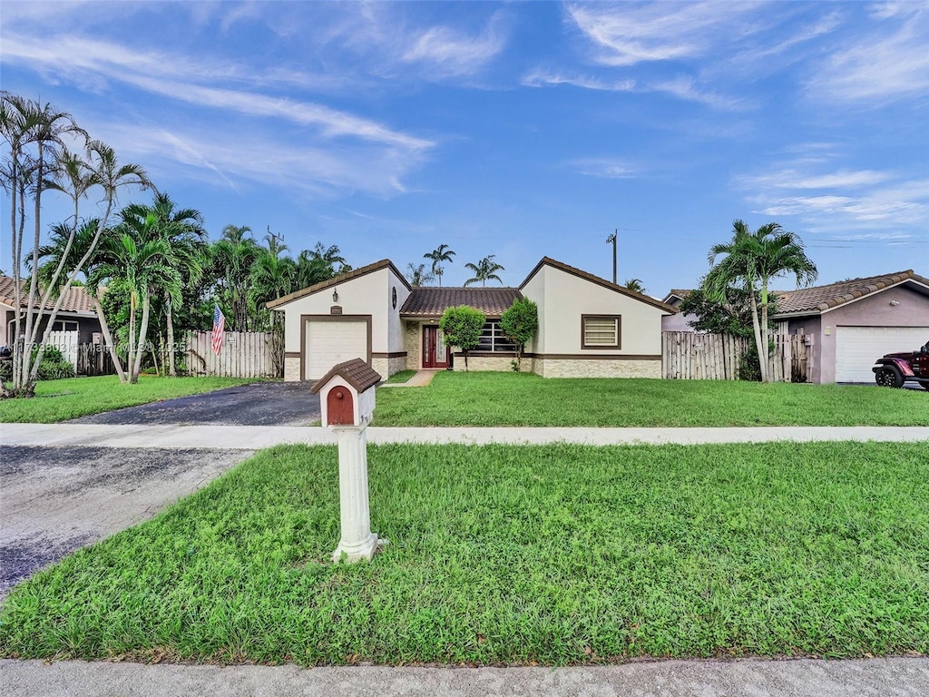 view of front of home featuring a garage and a front lawn