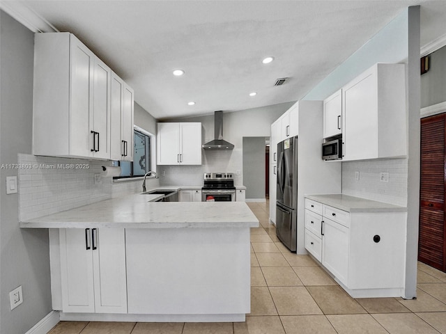 kitchen with white cabinetry, wall chimney exhaust hood, and stainless steel appliances