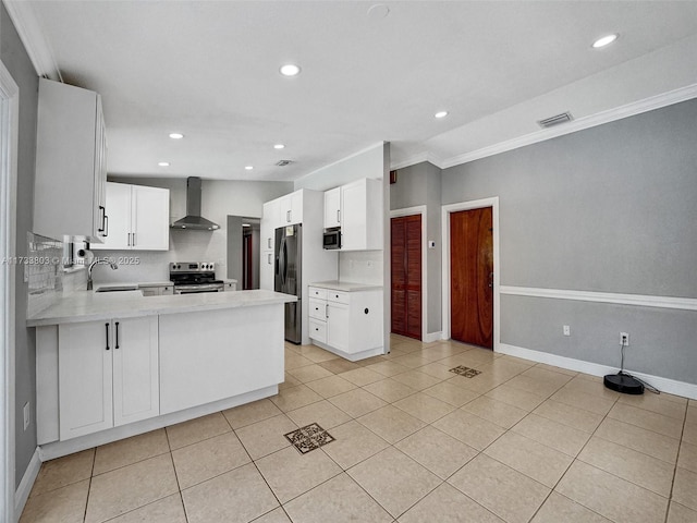 kitchen featuring white cabinetry, light tile patterned floors, kitchen peninsula, stainless steel appliances, and wall chimney range hood