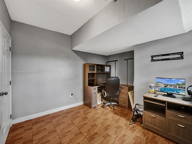 home office featuring a textured ceiling