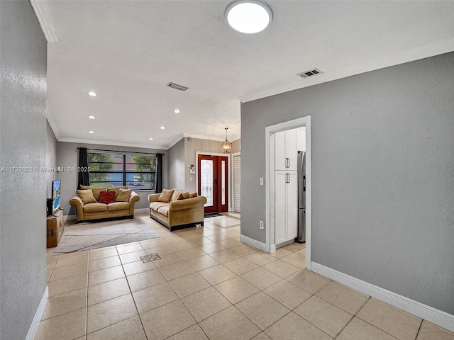 living room with crown molding and light tile patterned flooring