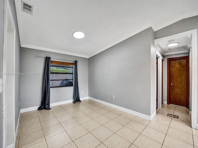 unfurnished room with crown molding and light tile patterned floors