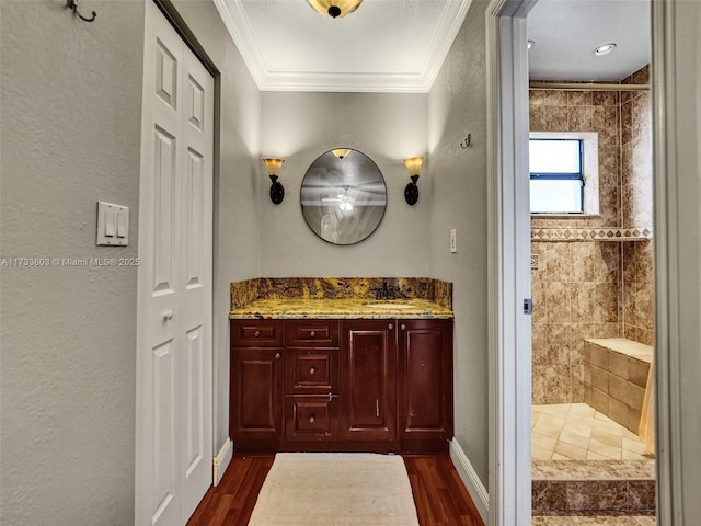 bathroom with crown molding, tiled shower, and hardwood / wood-style flooring