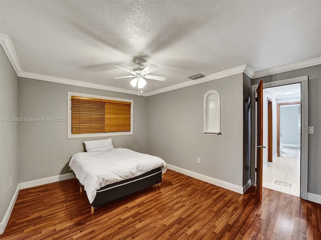 bedroom featuring crown molding, ceiling fan, dark hardwood / wood-style floors, and a textured ceiling