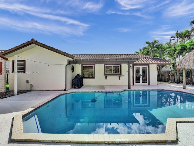 view of pool with a patio and french doors