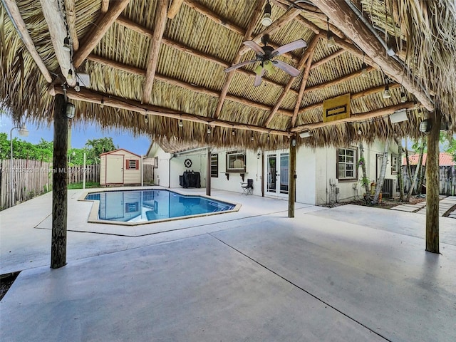 view of pool featuring a patio, a storage unit, ceiling fan, central air condition unit, and a gazebo