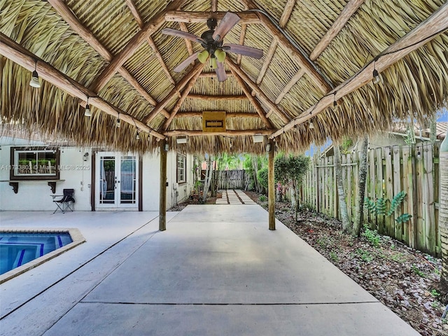 view of swimming pool featuring a gazebo, ceiling fan, a patio area, and french doors