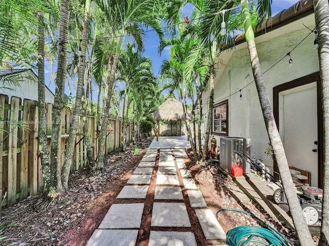 view of yard featuring a patio area and central air condition unit