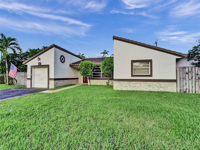 view of front of home with a garage and a front lawn